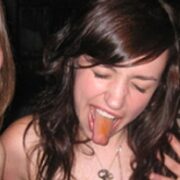 A woman with her tongue hanging out of her mouth.