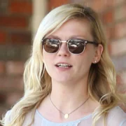A woman wearing sunglasses and a necklace.