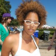 A woman with glasses and a white shirt