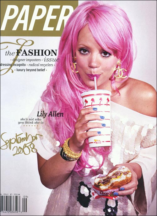 A woman with pink hair drinking from a cup.