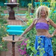 A woman in a blue skirt and purple top