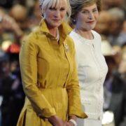 Two women in yellow and white standing next to each other.