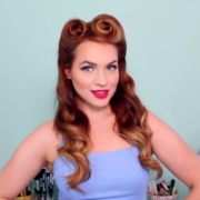 A woman with red hair and two buns on her head.