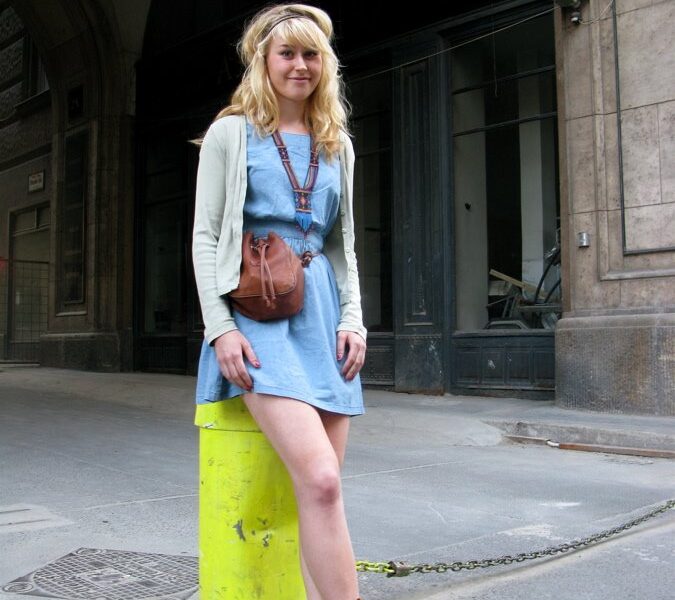 A woman standing on top of a skateboard.