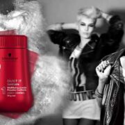 A woman with short hair and a red bottle of hair powder.