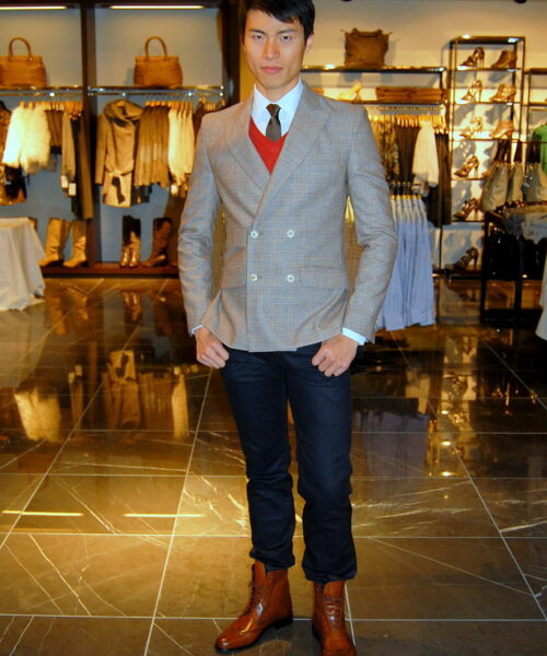 A man in a suit and tie standing on the floor.