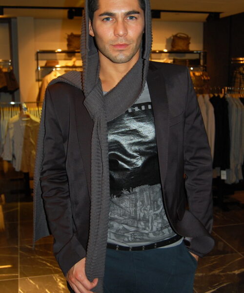 A man in black jacket and gray shirt