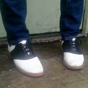 A person standing on the ground wearing shoes.