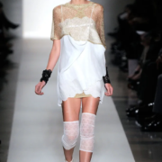 A model walks the runway in a white dress.