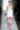A model walks the runway in a white dress.