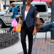 A woman in black pants and a blue jacket