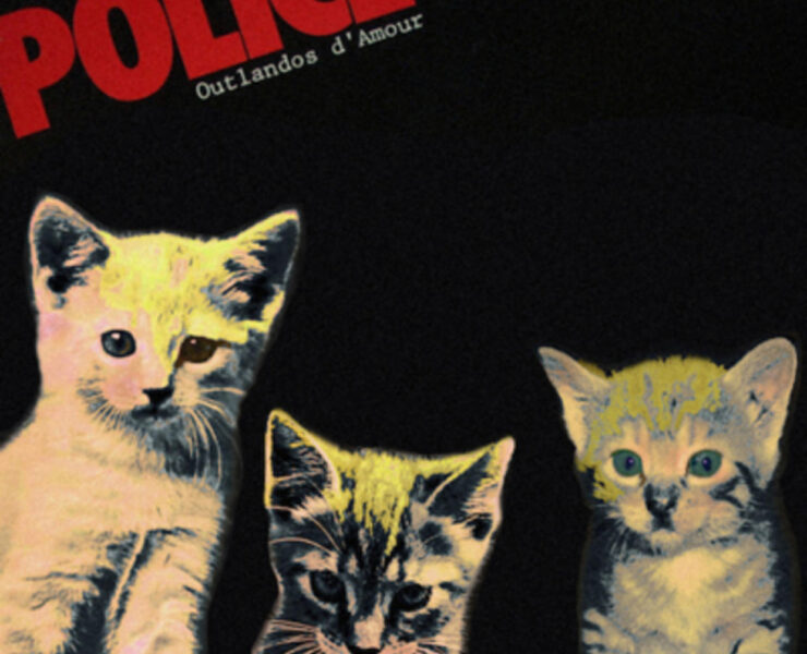 Three kittens are sitting in front of a police poster.