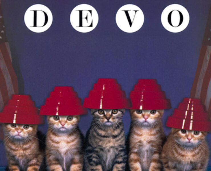 A group of cats wearing red hats on top of their heads.