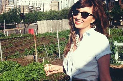 A woman holding a glass of wine in her hand.