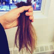 A person holding some hair in their hand