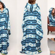 A woman in a hooded blanket is posing for the camera.